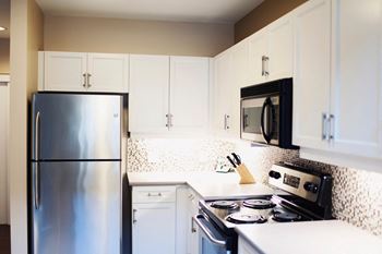 Kitchen with white cabinets and stainless steel appliances